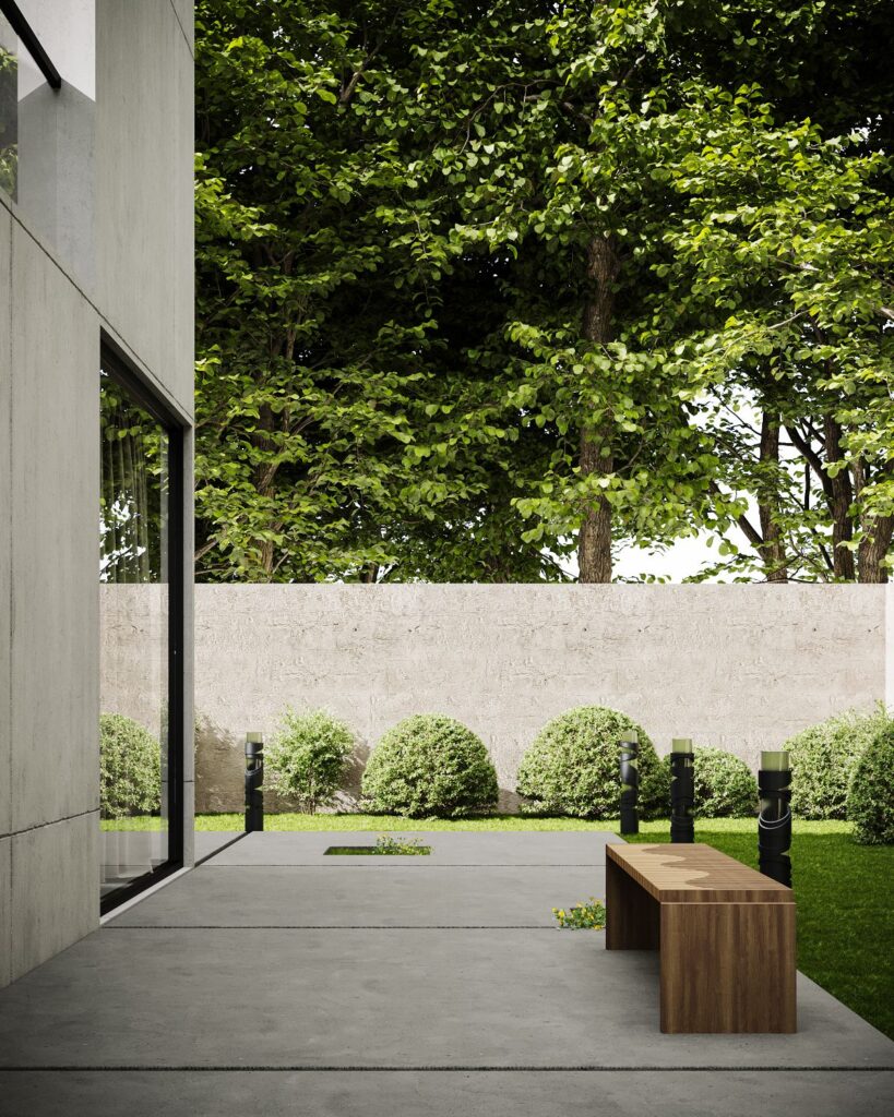 Minimalist concrete patio with wooden bench and garden