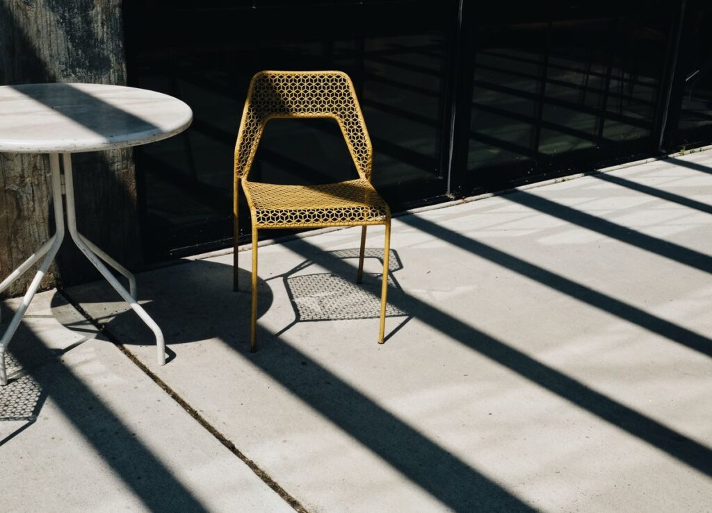 Sunlit concrete patio with outdoor seating